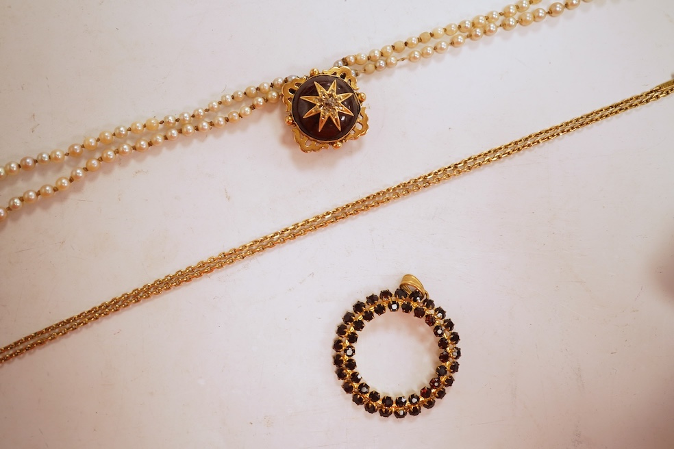 Two necklaces, comprising: a three-strand cultured pearl necklace, to a cabochon garnet and diamond clasp, length 34cm; and a paste and gilt metal pendant on a gold chain, chain length 44cm, stamped 14K, gross weight of